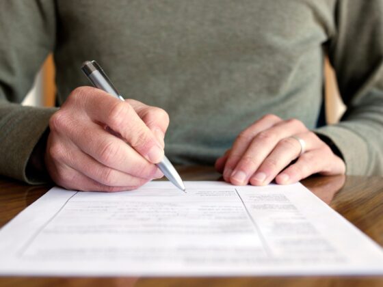 The man signs